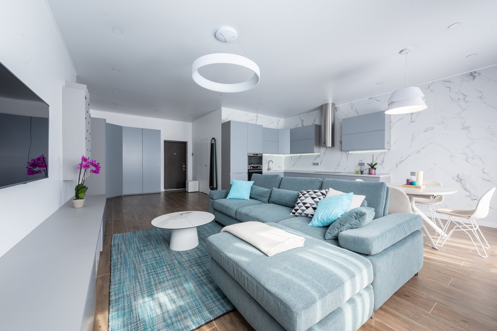 studio interior with sofa near table and kitchen
